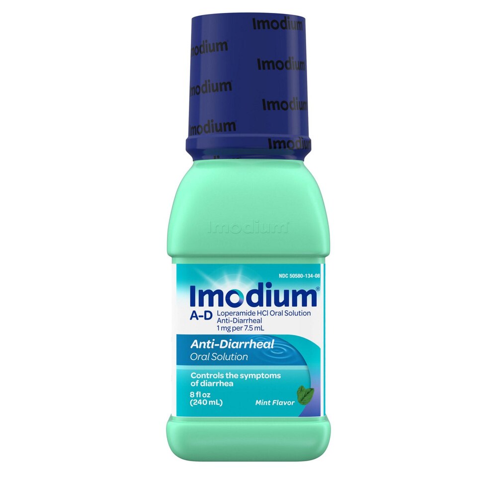 Imodium A-D bottle with blue cap and green body on a white background