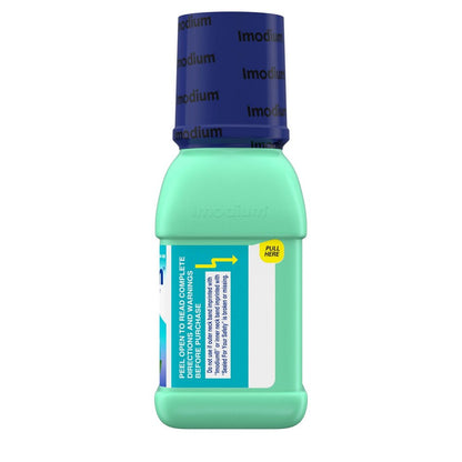 Green bottle with blue cap labeled 'imodium' on a white background