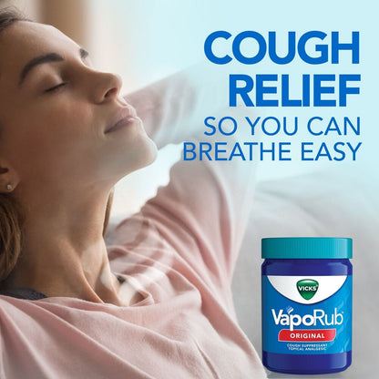 Woman lying down with Vicks VapoRub jar on a light background