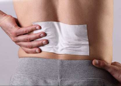 Person applying a white patch to their lower back with text 'Easy-to-Apply Targeted Pain Relief' on a yellow background.