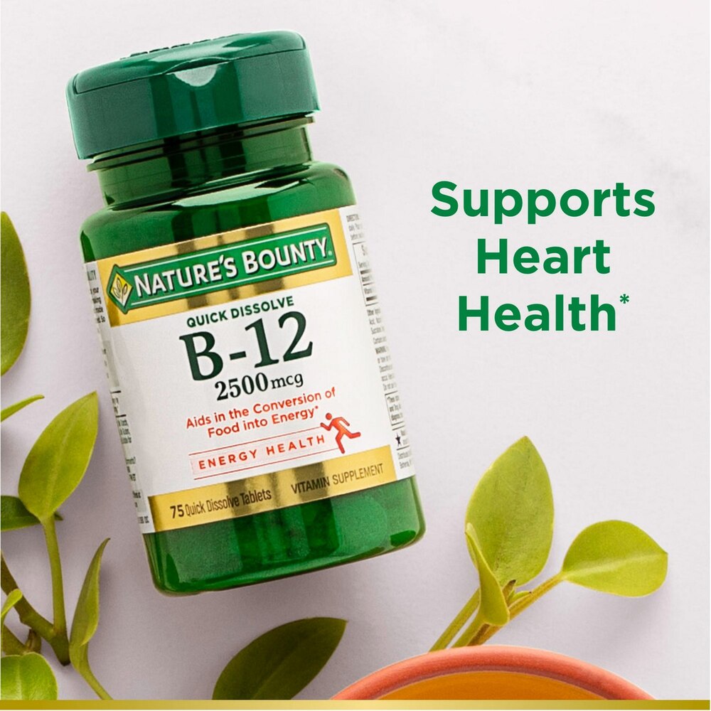 Nature's Bounty B-12 supplement bottle with green leaves on a light background